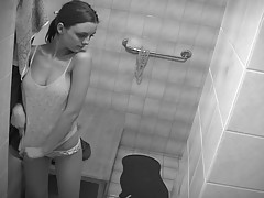 There`s a spy cam in this bathroom and this adorable brunette teen has no idea she`s being filmed as she strips out of her clothes, revealing all of her tender body.